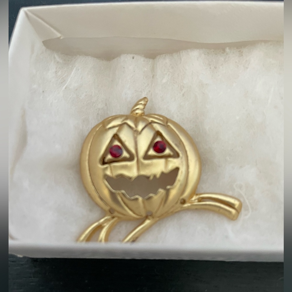 Gold Tone Jack-o-lantern Pin with Ruby Red Eyes.